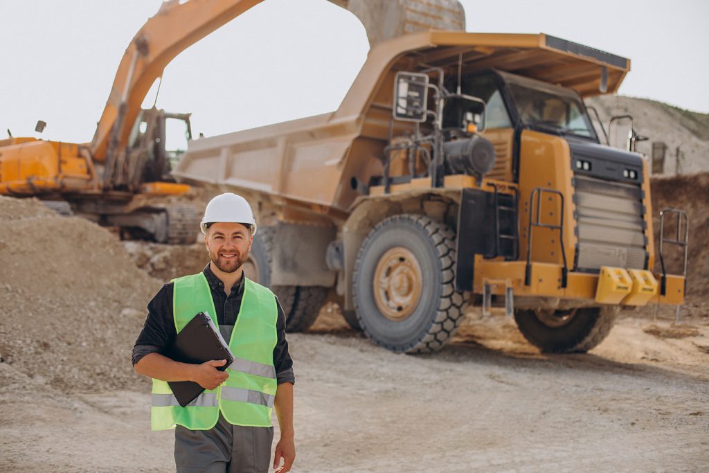 Male worker with bulldozer in sand quarry